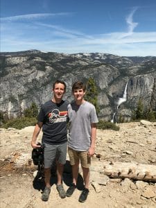 Todd and Brett Plunkett at Sentinel Dome with Yosemite Falls in the background